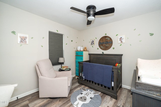 bedroom with ceiling fan, wood finished floors, and baseboards