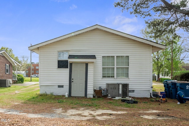 back of house with cooling unit and crawl space