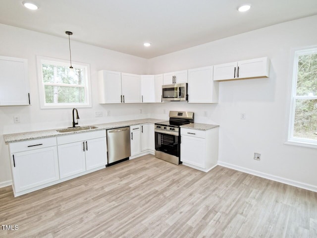 48 S Grace Way, Henderson, NC 27537 - kitchen featuring light wood-style flooring, stainless steel appliances, white cabinetry, and a sink