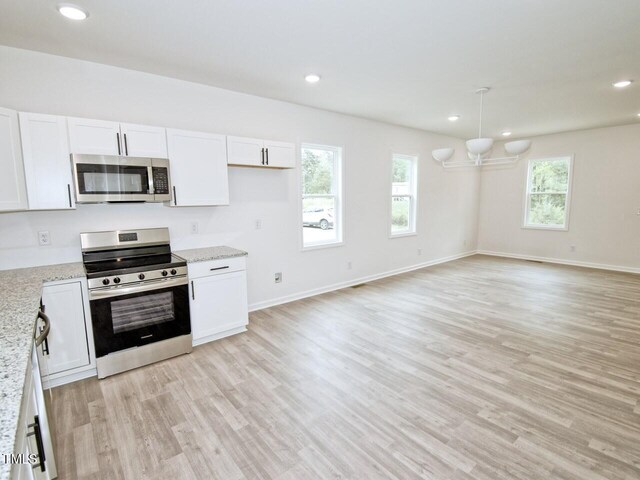 48 S Grace Way, Henderson, NC 27537 - kitchen featuring an inviting chandelier, light stone countertops, light wood-style flooring, appliances with stainless steel finishes, and white cabinetry