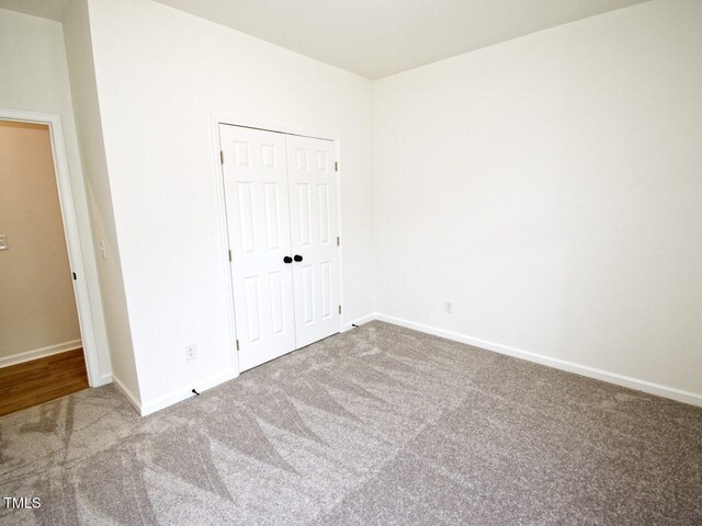 48 S Grace Way, Henderson, NC 27537 - unfurnished bedroom with carpet floors, a closet, and baseboards