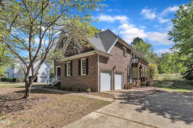 view of home's exterior featuring brick siding, driveway, a shingled roof, and a garage