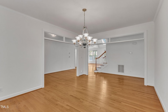 unfurnished dining area featuring stairway, visible vents, crown molding, a chandelier, and light wood-style flooring