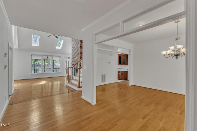 interior space featuring stairway, visible vents, a skylight, baseboards, and a chandelier