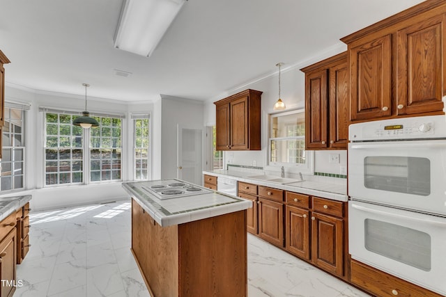 kitchen featuring a sink, white appliances, marble finish floor, tile counters, and ornamental molding