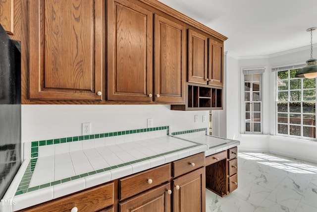 kitchen featuring marble finish floor, open shelves, decorative light fixtures, crown molding, and brown cabinetry