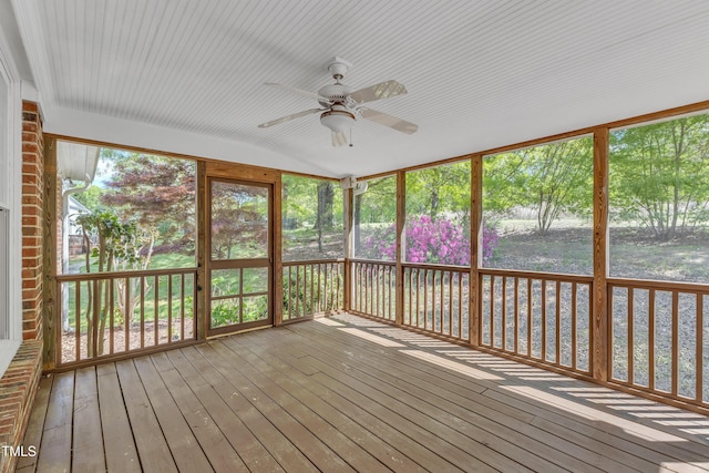 unfurnished sunroom with ceiling fan