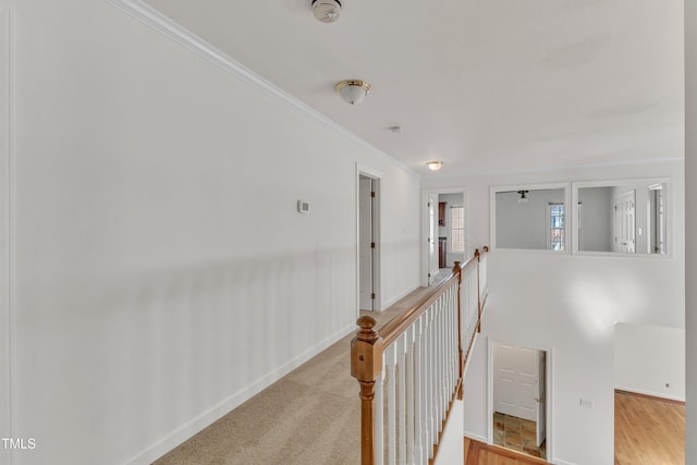 hall with an upstairs landing and ornamental molding