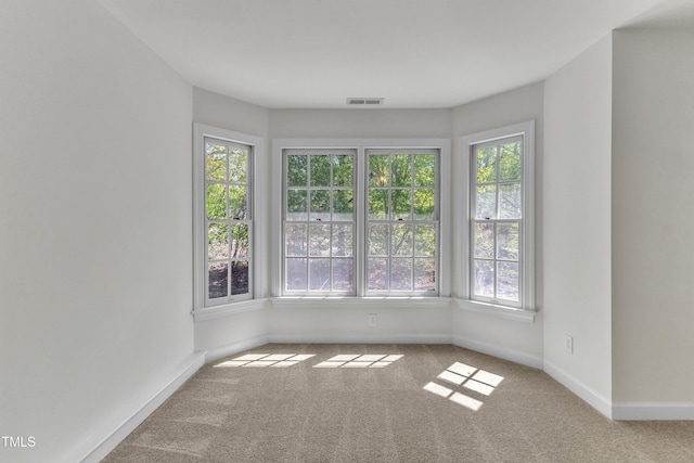 carpeted empty room with baseboards and visible vents