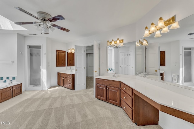 bathroom with a shower stall, a bath, vanity, ceiling fan, and visible vents