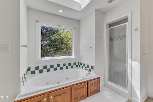 full bath with a shower stall, tile patterned floors, a jetted tub, baseboards, and visible vents
