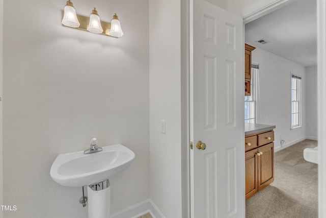 bathroom with baseboards and visible vents