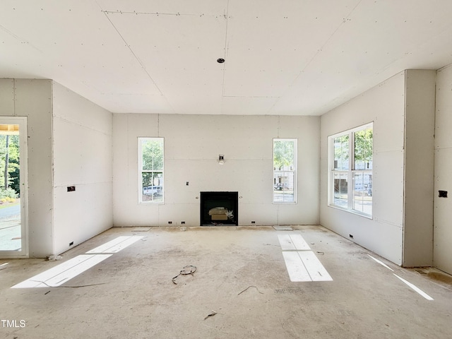 unfurnished living room featuring plenty of natural light