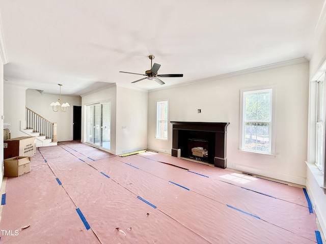 3817 Coach Lantern Ave, Wake Forest, NC 27587 - unfurnished living room featuring plenty of natural light, ornamental molding, a fireplace, stairway, and ceiling fan