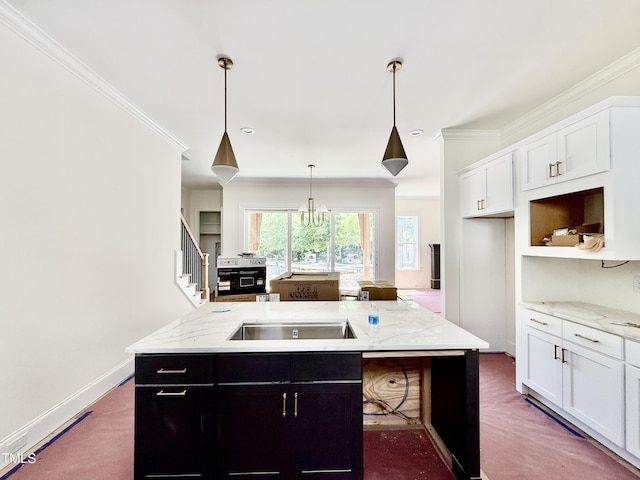 3817 Coach Lantern Ave, Wake Forest, NC 27587 - kitchen featuring crown molding, white cabinetry, an island with sink, light stone countertops, and pendant lighting
