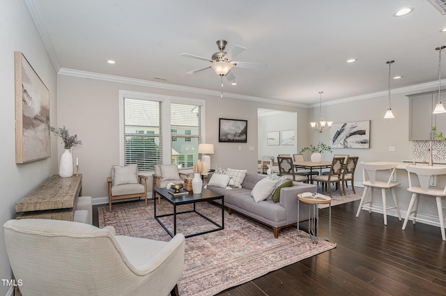 living area with crown molding, baseboards, dark wood-type flooring, recessed lighting, and ceiling fan with notable chandelier