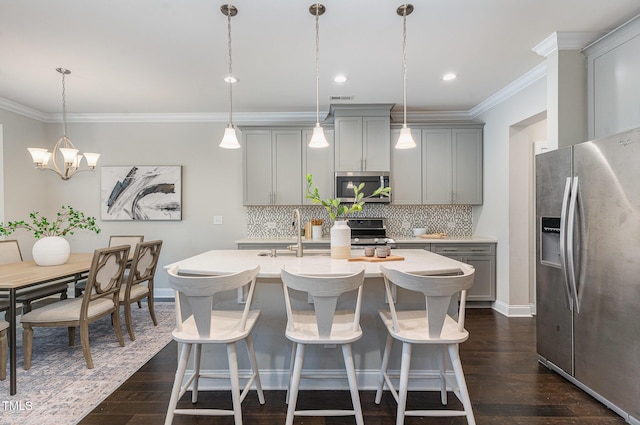 kitchen featuring crown molding, light countertops, backsplash, gray cabinetry, and stainless steel appliances