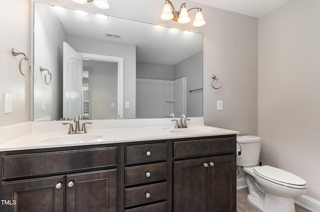 full bathroom with double vanity, toilet, visible vents, and a sink
