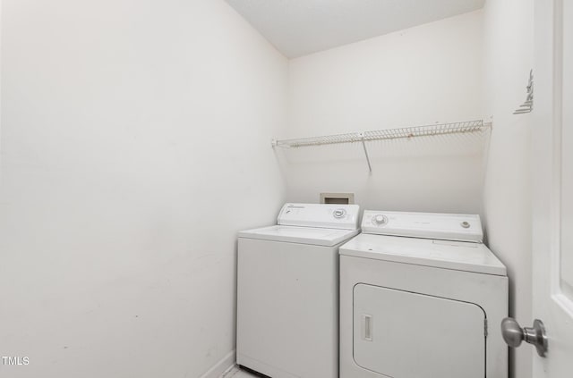 laundry room with washer and clothes dryer, laundry area, and baseboards