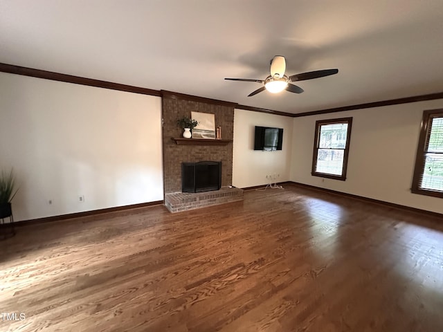 2708 Halfhitch Trl, Raleigh, NC 27615 - unfurnished living room featuring crown molding, dark wood-style floors, baseboards, a ceiling fan, and a brick fireplace