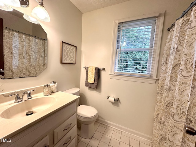 2708 Halfhitch Trl, Raleigh, NC 27615 - full bathroom featuring vanity, toilet, tile patterned flooring, baseboards, and a textured ceiling