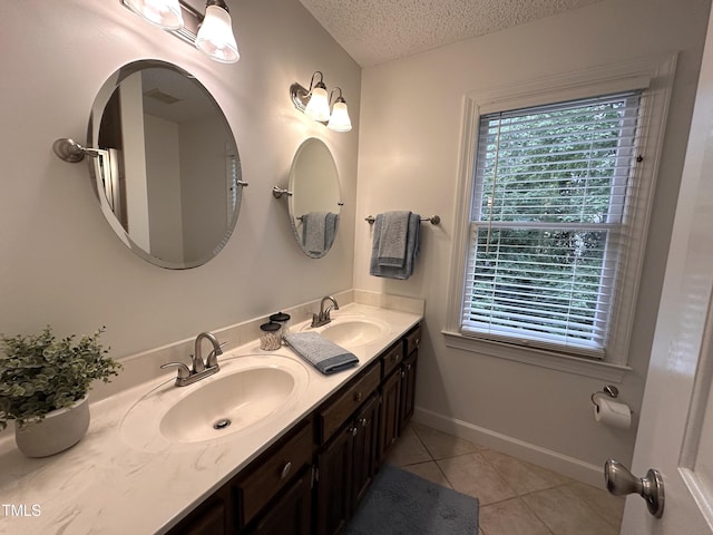 2708 Halfhitch Trl, Raleigh, NC 27615 - full bathroom with a textured ceiling, tile patterned floors, double vanity, and baseboards