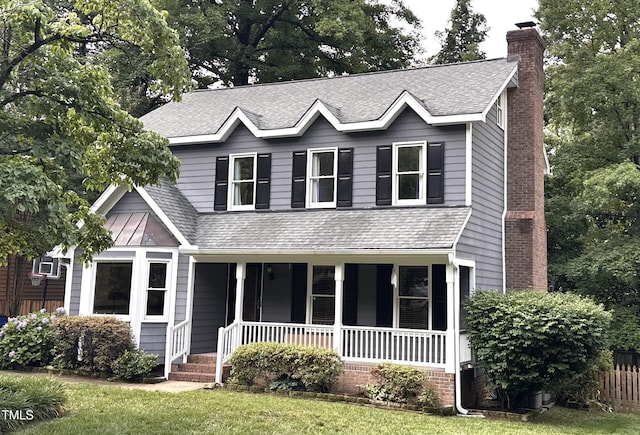 2708 Halfhitch Trl, Raleigh, NC 27615 - view of front of property featuring a chimney, a porch, roof with shingles, and a front lawn