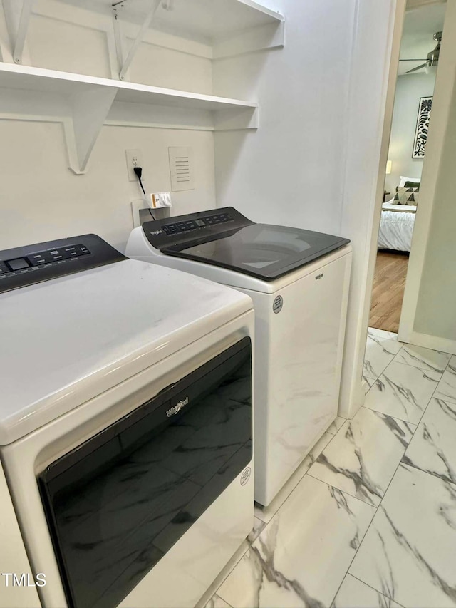 washroom with marble finish floor, a ceiling fan, laundry area, and independent washer and dryer