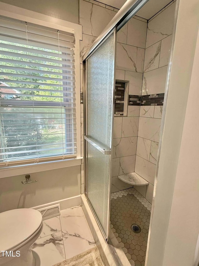 full bathroom featuring marble finish floor, toilet, visible vents, and a stall shower