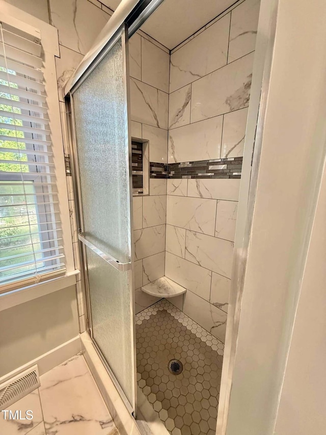 full bath featuring marble finish floor, visible vents, and a stall shower