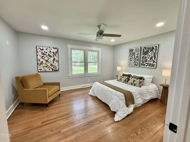 bedroom featuring recessed lighting, wood finished floors, visible vents, a ceiling fan, and baseboards