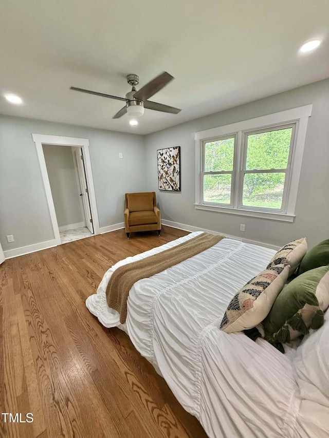 bedroom with baseboards, wood finished floors, recessed lighting, and ceiling fan