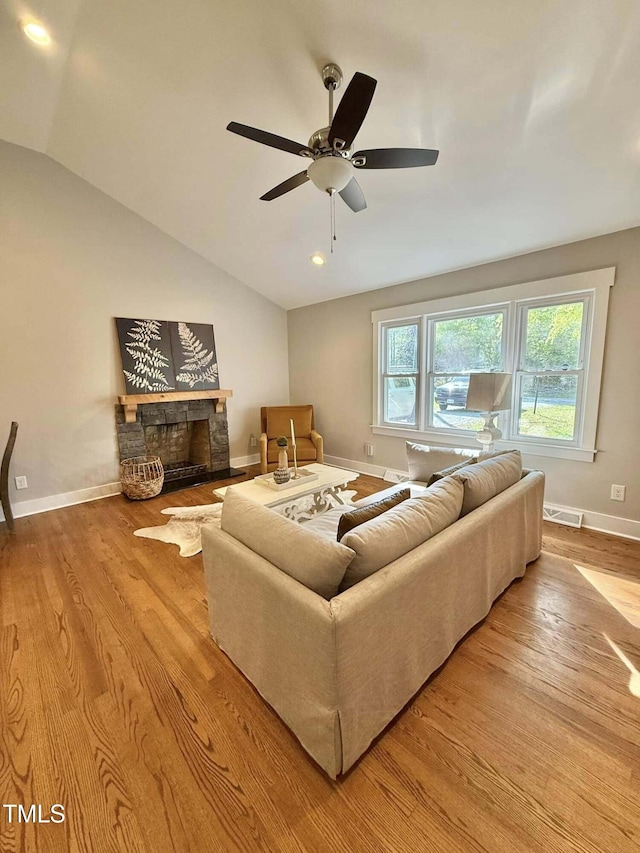 living room with baseboards, a ceiling fan, wood finished floors, and visible vents