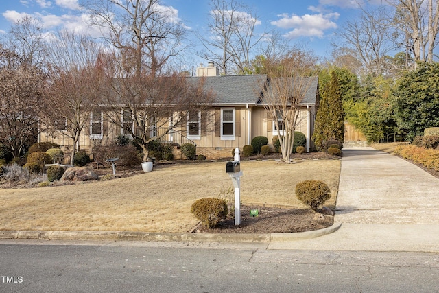 single story home featuring crawl space, driveway, a chimney, and roof with shingles