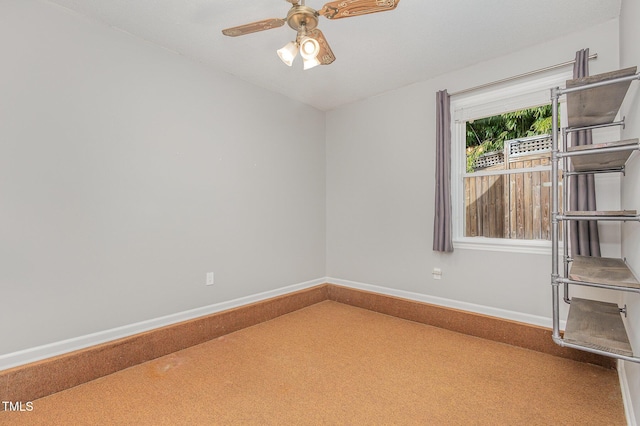 unfurnished room with baseboards, ceiling fan, and carpet