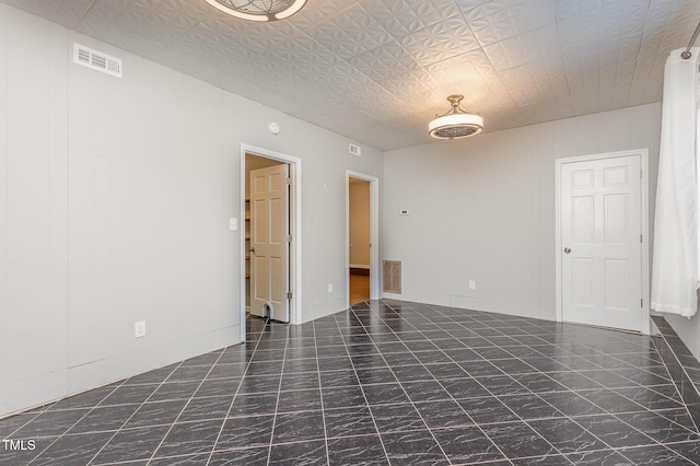 unfurnished room with visible vents and marble finish floor
