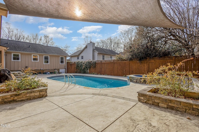 view of swimming pool with a patio area, a fenced backyard, an in ground hot tub, and a fenced in pool