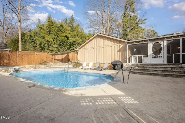 view of pool featuring a fenced in pool, a patio, a fenced backyard, and a sunroom