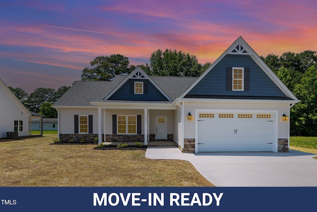 1000 Peedin Rd, Selma, NC 27576 - view of front of house with stone siding, driveway, a porch, and a yard
