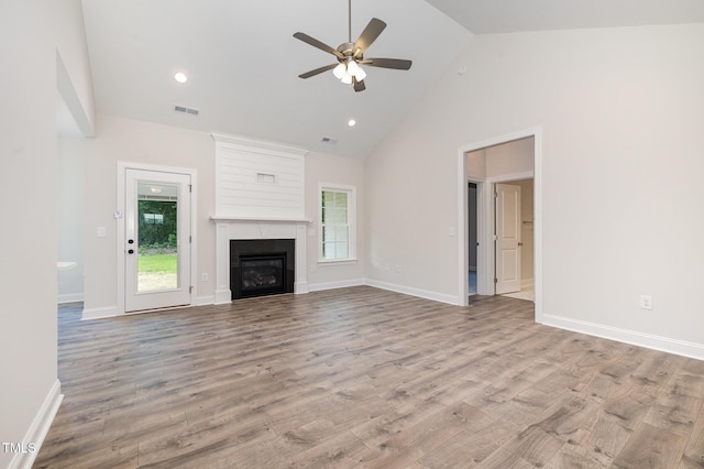 1000 Peedin Rd, Selma, NC 27576 - unfurnished living room with high vaulted ceiling, ceiling fan, plenty of natural light, wood finished floors, and a fireplace