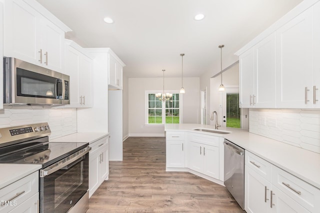 1000 Peedin Rd, Selma, NC 27576 - kitchen featuring appliances with stainless steel finishes, white cabinetry, a chandelier, light countertops, and recessed lighting