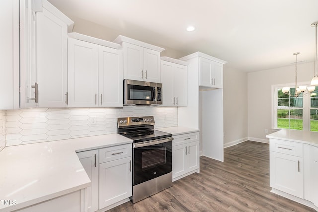 1000 Peedin Rd, Selma, NC 27576 - kitchen with appliances with stainless steel finishes, white cabinetry, backsplash, light countertops, and a chandelier