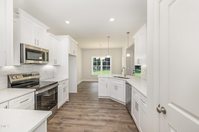 1000 Peedin Rd, Selma, NC 27576 - kitchen with appliances with stainless steel finishes, decorative backsplash, light countertops, white cabinets, and recessed lighting