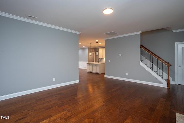 1007 Fairhaven Dr, Mebane, NC 27302 - unfurnished living room with a sink, dark wood-style flooring, visible vents, stairway, and crown molding