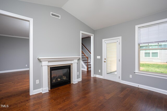 1007 Fairhaven Dr, Mebane, NC 27302 - unfurnished living room featuring vaulted ceiling, a glass covered fireplace, visible vents, wood finished floors, and stairway