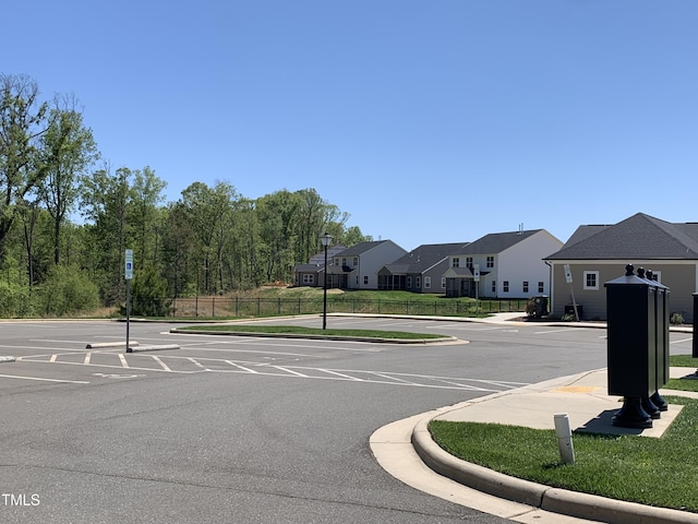 1007 Fairhaven Dr, Mebane, NC 27302 - view of road with street lighting, sidewalks, curbs, a residential view, and traffic signs