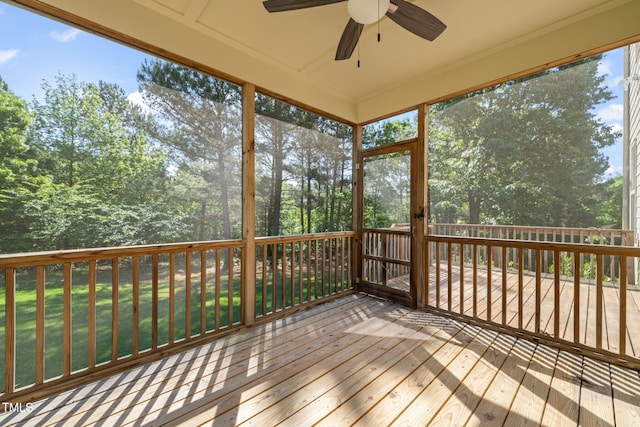 unfurnished sunroom featuring a ceiling fan