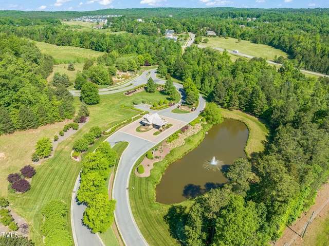 aerial view featuring a water view and a forest view