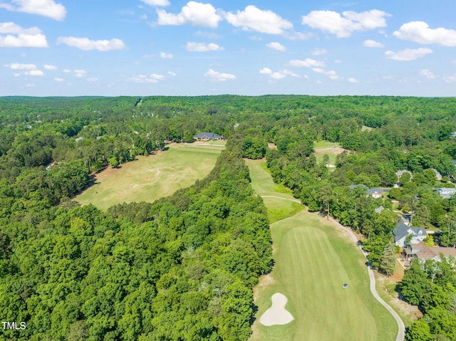 aerial view featuring a wooded view and golf course view