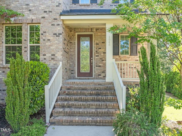 doorway to property featuring brick siding